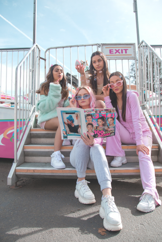 Model Amneet Singh, Natalie Cornegjo, Emma Bowder and Libby Morgan pose together on the steps of a bumper car ride and check out a J-14 Magazine for a slumber-party-like shot.