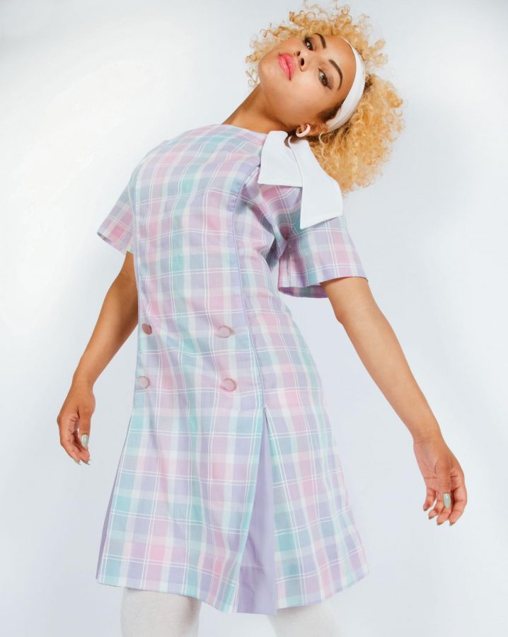 Genesis Hansen, outfitted in antique pastel plaid dress, white tights and headscarf.