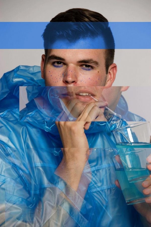 Model Robbie Portoni wears a transparent blue raincoat and jersey shirt from ASOS.